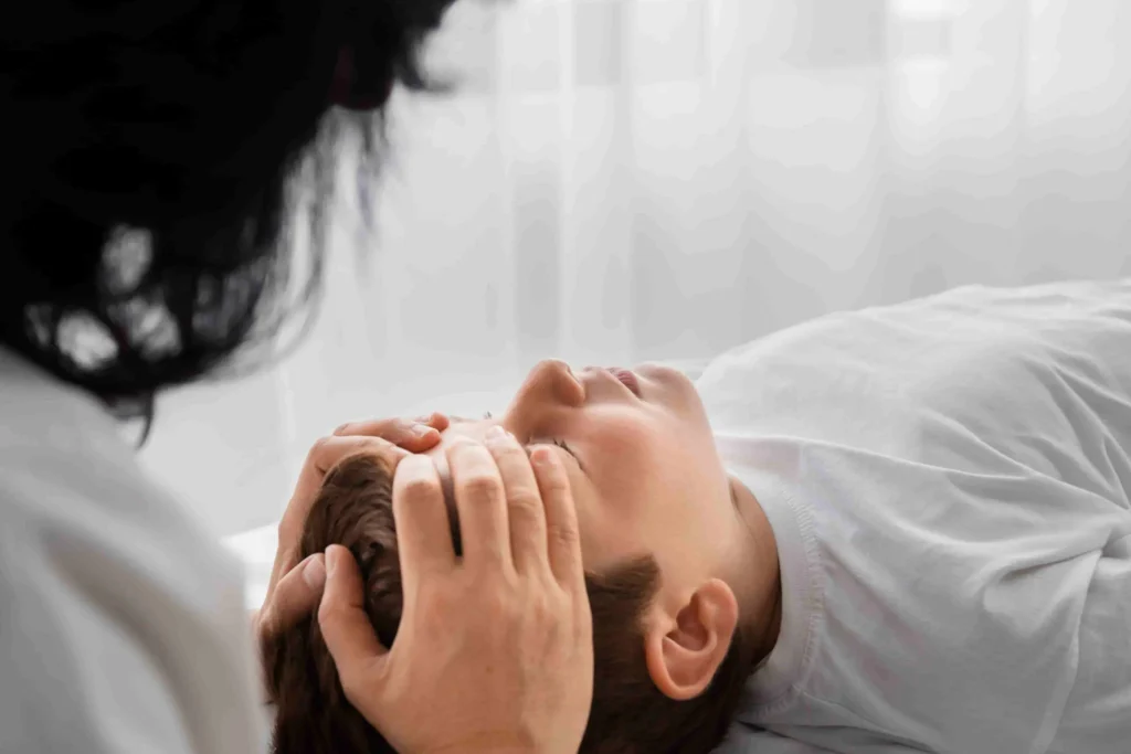 Chiropractor performing gentle head and neck therapy for headache relief