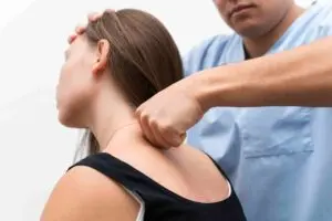 Chiropractor performing a neck adjustment to relieve neck pain