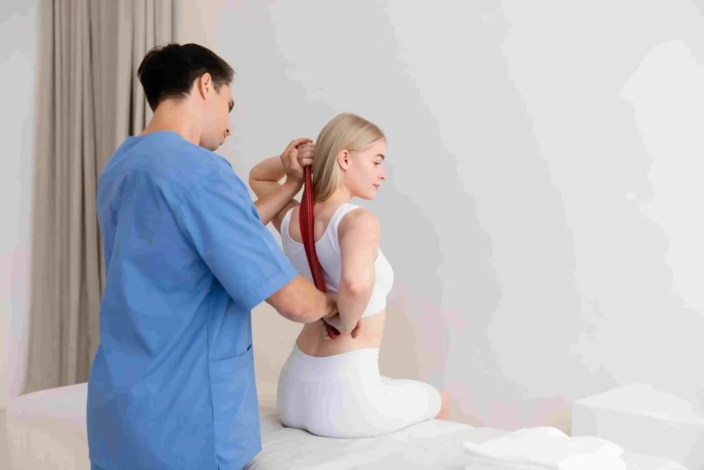 Chiropractor assisting a patient with lower back stretching for sciatica relief