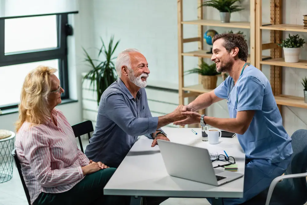 Doctor greeting an older patient during an in-office consultation.