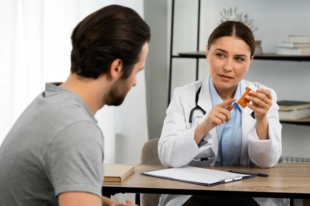 Functional medicine doctor consulting with a patient and explaining a personalized treatment plan using a prescription bottle in a clinical office setting.