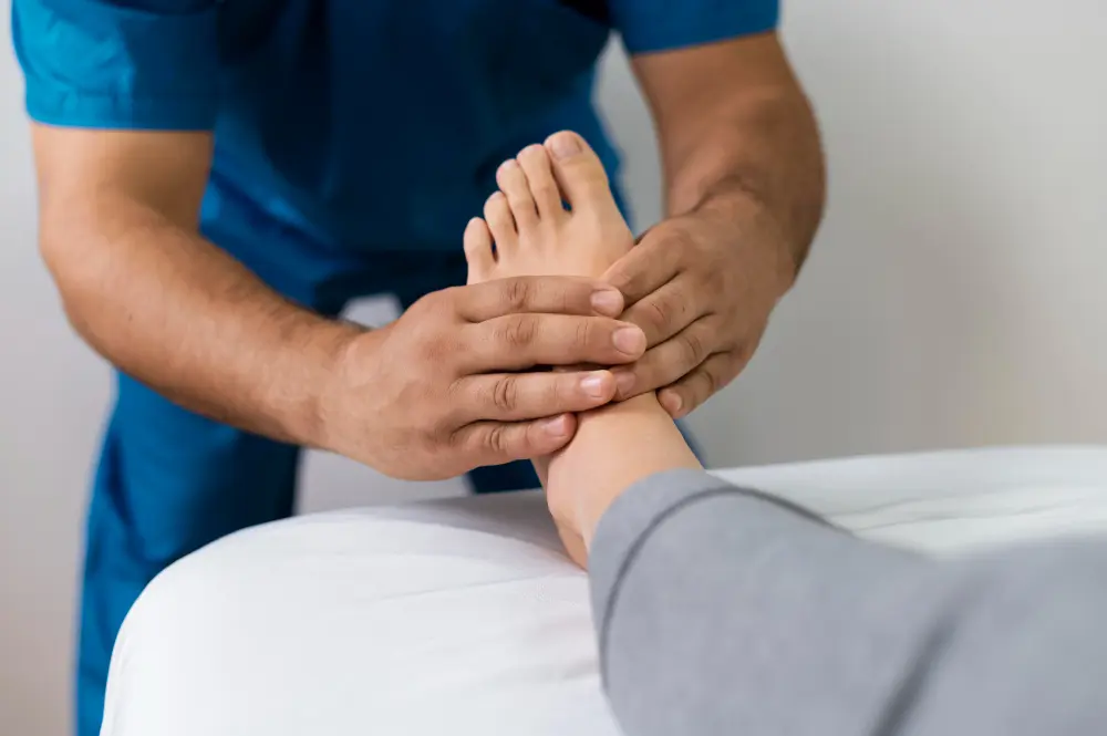 Therapist performing foot therapy on a patient’s ankle.