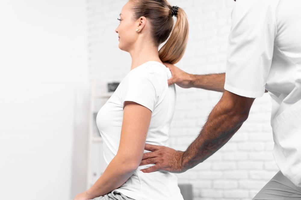 Person with poor posture while receiving evaluation for spinal alignment