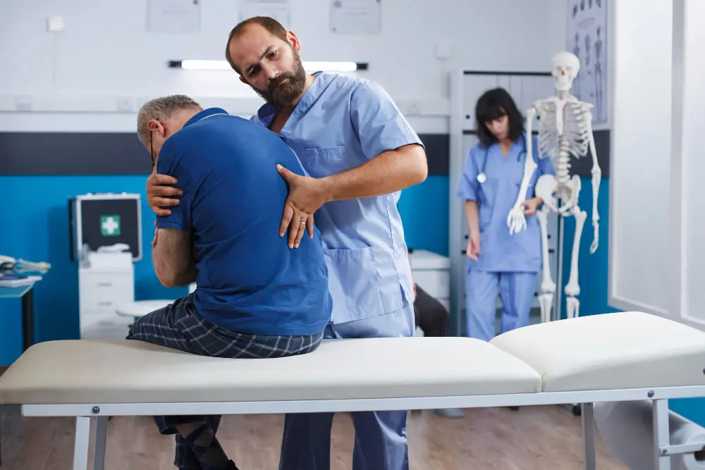 Chiropractor consulting with patient in Mishawaka clinic setting