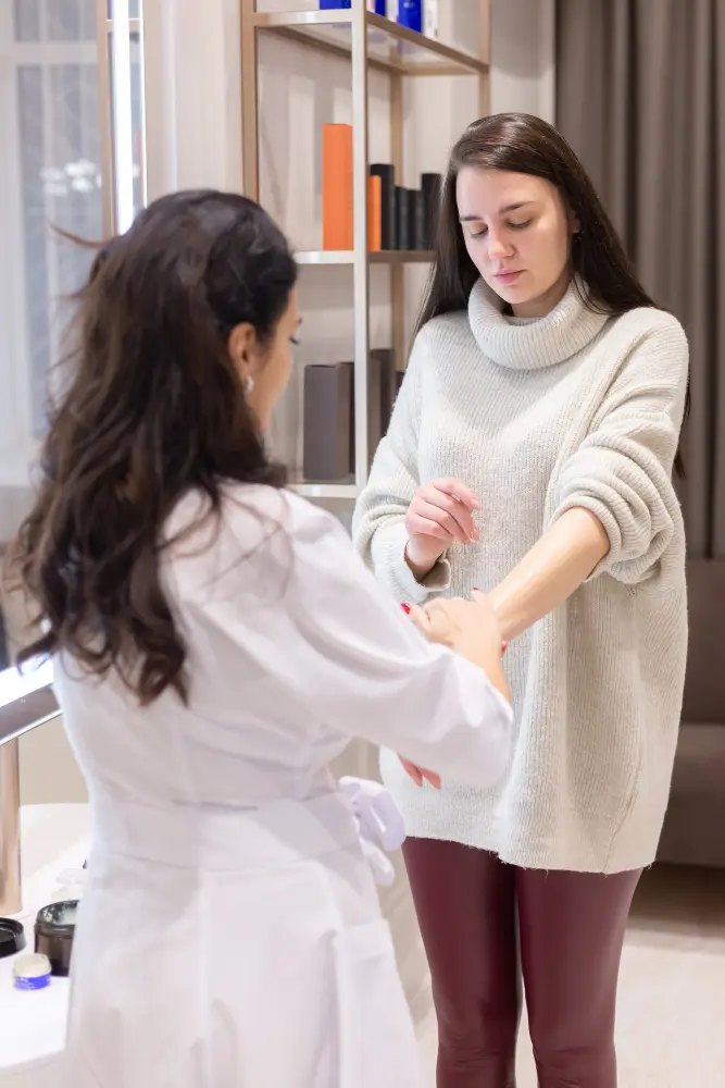 Healthcare practitioner performs a gentle hands-on assessment of a female patient’s arm during a functional medicine evaluation in a calm, clinical environment.