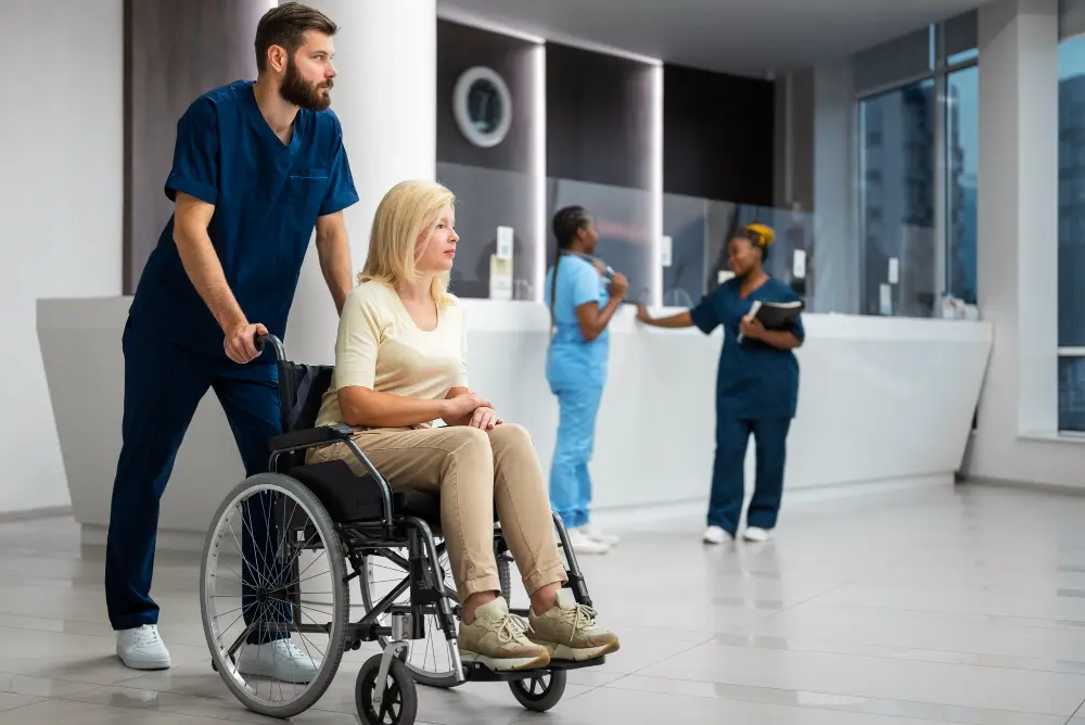 Medical staff assisting a patient in a wheelchair at an accessible healthcare facility reception area