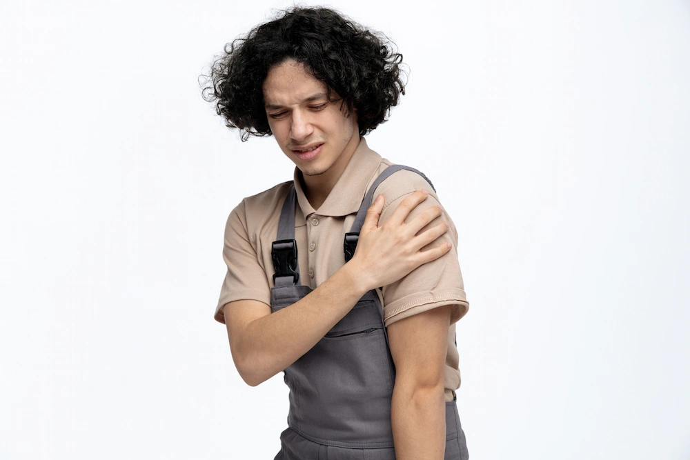 Person holding shoulder due to rotator cuff pain and injury