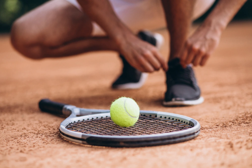 Person holding elbow in pain from tennis elbow condition