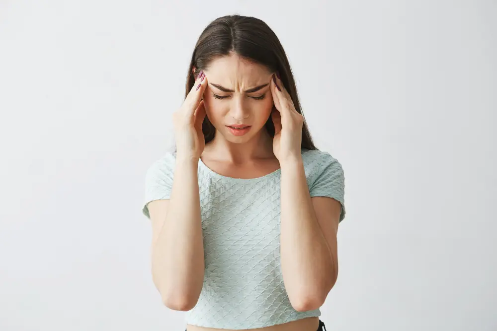 Woman experiencing head pain and tension headache