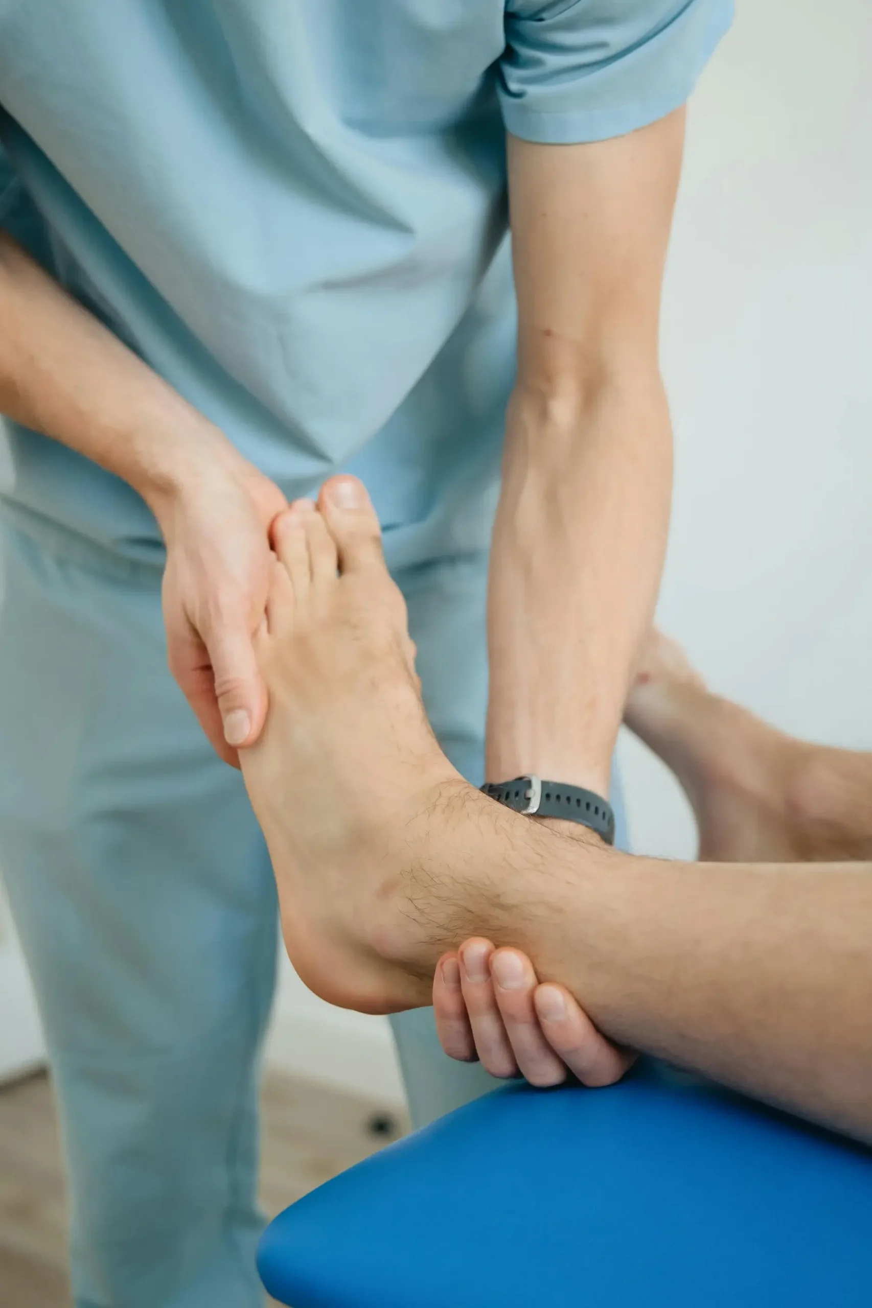 Chiropractor assessing patients foot from pain in the feet