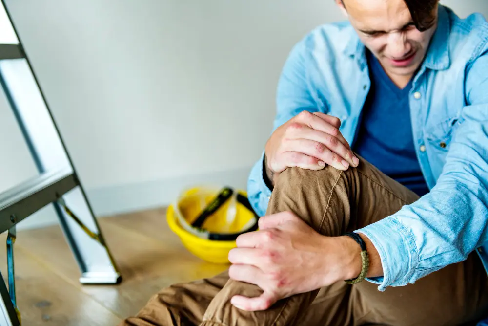 Federal employee experiencing knee pain after a workplace accident, highlighting a job-related injury claim scenario.